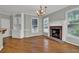 Bright living room boasts a brick fireplace, hardwood floors, and built-in cabinets and shelving at 4330 Old Oak Trce, Cumming, GA 30041