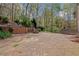 Flagstone patio with fire pit and retaining wall, creating a cozy outdoor living space at 4330 Old Oak Trce, Cumming, GA 30041