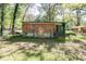 Rear view of a modest brick home, showcasing the backyard and potential for landscaping at 4479 Richard Rd, Conley, GA 30288