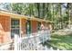 Close-up of a brick home with a green door and a white picket fence at 4479 Richard Rd, Conley, GA 30288