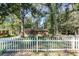 Charming brick home with a white picket fence and lush trees surrounding the property at 4479 Richard Rd, Conley, GA 30288
