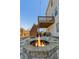 Charming backyard featuring a stone fire pit area, wooden deck, and ample space for outdoor gatherings at 6350 Boulder Rdg, Cumming, GA 30028