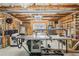 Unfinished basement with a large work table, and shelving units at 6350 Boulder Rdg, Cumming, GA 30028