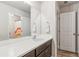 Bathroom featuring a large mirror, vanity, and an open doorway leading to a shower/tub at 6350 Boulder Rdg, Cumming, GA 30028