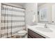 Cozy bathroom featuring a shower with patterned curtain, and a white vanity at 6350 Boulder Rdg, Cumming, GA 30028