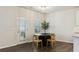 Cozy breakfast room features hardwood floors, a modern table with seating for four, and a glass paneled door at 6350 Boulder Rdg, Cumming, GA 30028