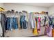 Spacious walk in closet featuring multiple rows of hanging clothes and ample shelf space at 6350 Boulder Rdg, Cumming, GA 30028