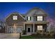 Charming two-story home featuring a brick and siding exterior, covered porch, and well-manicured front yard at 6350 Boulder Rdg, Cumming, GA 30028