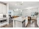 Open concept kitchen featuring granite counters, stainless appliances, and views into an adjacent Gathering and breakfast room at 6350 Boulder Rdg, Cumming, GA 30028