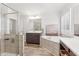 Bright bathroom featuring a large soaking tub, glass shower, dual sink vanities, and shuttered windows at 6350 Boulder Rdg, Cumming, GA 30028