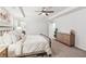 Bright main bedroom with carpet, ceiling fan, dresser, and art on the wall at 6350 Boulder Rdg, Cumming, GA 30028