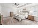 Spacious main bedroom suite with tray ceiling, carpet flooring, and natural light from shuttered windows at 6350 Boulder Rdg, Cumming, GA 30028