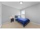 Bedroom has a cozy design with carpet flooring and neutral walls at 7013 Mahonia Pl, Lithonia, GA 30038