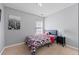 Cozy bedroom features carpet, light gray walls, and a large picture at 7013 Mahonia Pl, Lithonia, GA 30038