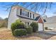 Well-maintained two-story home with vinyl siding and manicured landscaping at 7013 Mahonia Pl, Lithonia, GA 30038