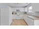 Well-lit kitchen featuring white appliances, cabinetry, and ample counter space at 7013 Mahonia Pl, Lithonia, GA 30038