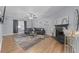Open-concept living room with fireplace, hardwood floors, and modern decor at 7013 Mahonia Pl, Lithonia, GA 30038