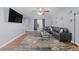 Bright living room featuring a large black sectional and neutral gray wall paint at 7013 Mahonia Pl, Lithonia, GA 30038
