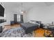 Spacious main bedroom with hardwood flooring, a ceiling fan and modern decor at 7013 Mahonia Pl, Lithonia, GA 30038