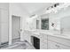 Bright bathroom featuring a double vanity with white cabinets and modern fixtures, plus a tiled shower at 2387 Battle Dr, Villa Rica, GA 30180