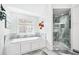 Modern bathroom with soaking tub, glass-enclosed shower, and stylish fixtures at 2387 Battle Dr, Villa Rica, GA 30180