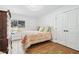 Cozy bedroom with hardwood floors featuring a bed, dresser, and window with a view at 2387 Battle Dr, Villa Rica, GA 30180