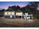 Charming back exterior of a dark sided home with multiple decks and staircase leading to the yard at 2387 Battle Dr, Villa Rica, GA 30180