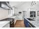 Bright kitchen featuring white cabinets, granite countertops, and stainless steel appliances at 2387 Battle Dr, Villa Rica, GA 30180