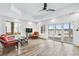 Comfortable living room with wicker furniture, large windows with a lake view, and hardwood floors at 2387 Battle Dr, Villa Rica, GA 30180