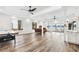 Spacious living room with hardwood floors, multiple windows overlooking the lake, and modern furnishings at 2387 Battle Dr, Villa Rica, GA 30180