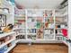 Walk-in pantry with ample shelving for organized storage and hardwood floors at 2387 Battle Dr, Villa Rica, GA 30180