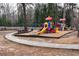 A bright and colorful playground with slides, swings, and climbing structures, set in a natural wooded area at 2387 Battle Dr, Villa Rica, GA 30180