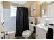 Compact bathroom featuring white tile, shower-tub combo, and stylish decorative accents at 2656 Northview Ave, Decatur, GA 30032