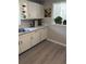 Cozy kitchen featuring white cabinets, marble countertops, and durable wood-look flooring at 2656 Northview Ave, Decatur, GA 30032