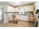 Inviting kitchen with white cabinetry, stainless sink, wood-look floors and natural light at 2656 Northview Ave, Decatur, GA 30032