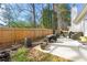 Backyard featuring a stone patio, grill, and a wooden fence for privacy at 4184 Wyndham Park Cir, Decatur, GA 30034