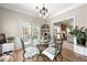 Bright breakfast nook with modern light fixture and decorative wrought iron table and chairs at 4184 Wyndham Park Cir, Decatur, GA 30034