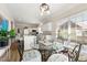 Sunlit breakfast nook with a glass top table, decorative chairs, and access to a modern kitchen at 4184 Wyndham Park Cir, Decatur, GA 30034