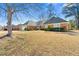 Well-maintained brick home with a manicured lawn and mature trees in a peaceful neighborhood at 4184 Wyndham Park Cir, Decatur, GA 30034