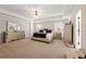 Large main bedroom suite with tray ceiling, carpet, and decorative furniture at 4184 Wyndham Park Cir, Decatur, GA 30034