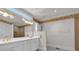 Bathroom with dual sink vanity, a large mirror, and decorative wallpaper at 300 Mill Creek Ct, Acworth, GA 30101
