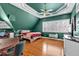 Bedroom featuring sloped ceilings, hardwood floors, and a bright window at 300 Mill Creek Ct, Acworth, GA 30101