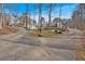 Circular driveway leading to a beautiful home surrounded by mature trees and lush landscaping at 300 Mill Creek Ct, Acworth, GA 30101