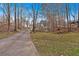 Winding driveway through a wooded landscape leading to the beautiful home at 300 Mill Creek Ct, Acworth, GA 30101