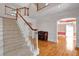 Grand staircase and hardwood floors in this home's stunning entryway at 300 Mill Creek Ct, Acworth, GA 30101