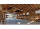 Unfinished garage interior with open ceiling, concrete floor, and workbench at 300 Mill Creek Ct, Acworth, GA 30101