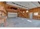 Spacious unfinished garage with stairs to a loft and workbench along wall at 300 Mill Creek Ct, Acworth, GA 30101