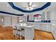 Bright kitchen with white cabinets, a center island with seating, and hardwood floors at 300 Mill Creek Ct, Acworth, GA 30101