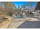 Aerial view of a backyard pool with stone patio and lush landscaping around it at 300 Mill Creek Ct, Acworth, GA 30101