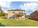 Exterior view of a two-story home with a well-manicured lawn and covered patio at 4162 Roberts Crest Dr, Suwanee, GA 30024